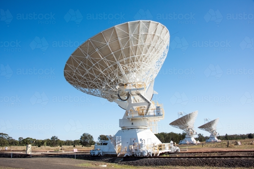 Close up of large radio telescope facing the blue sky day - Australian Stock Image