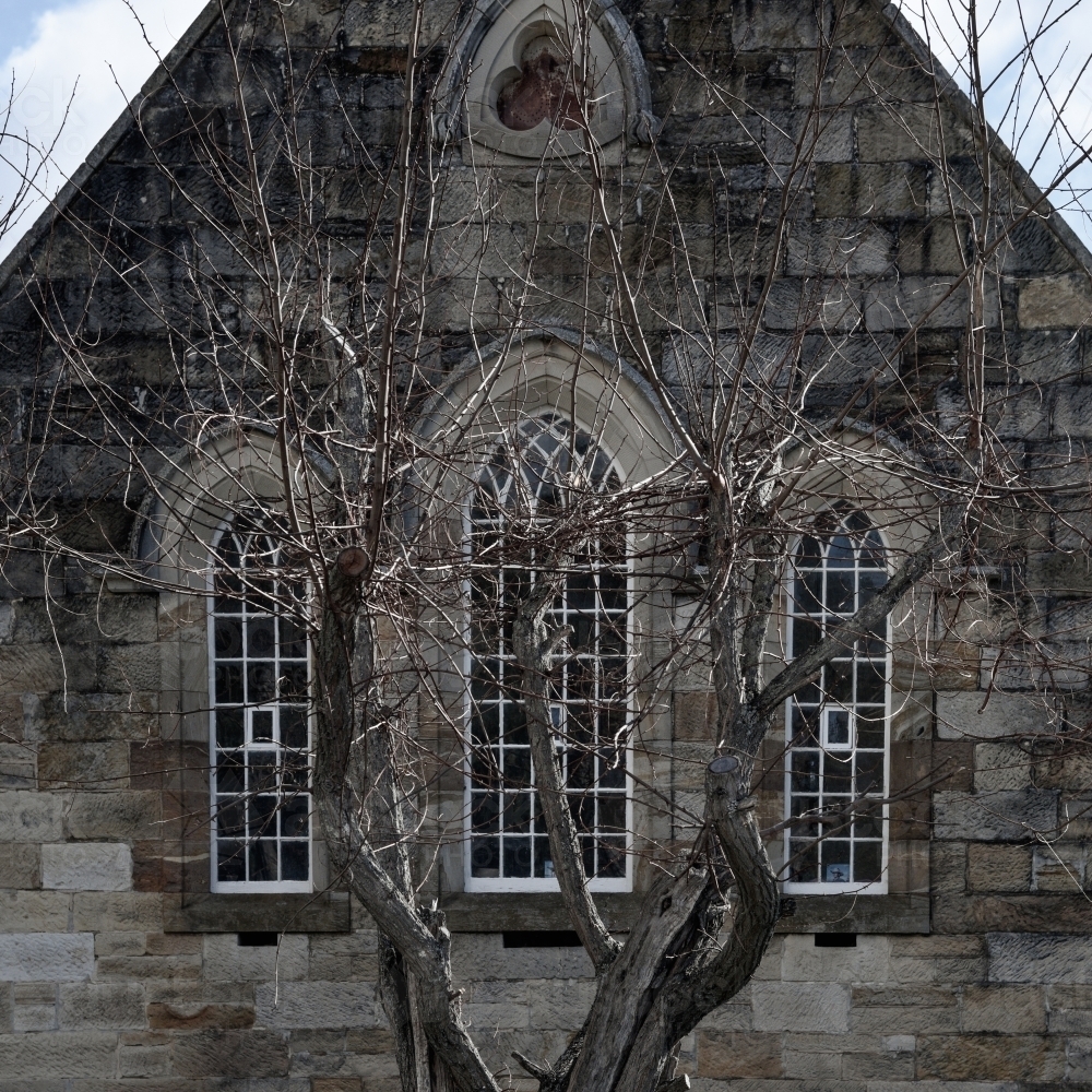 close up of limestone church window facade in winter - Australian Stock Image