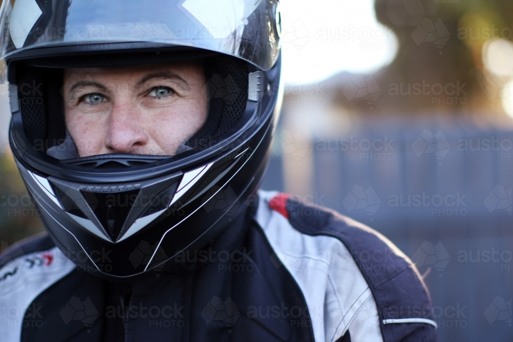 Close up of man wearing a motorbike helmet - Australian Stock Image