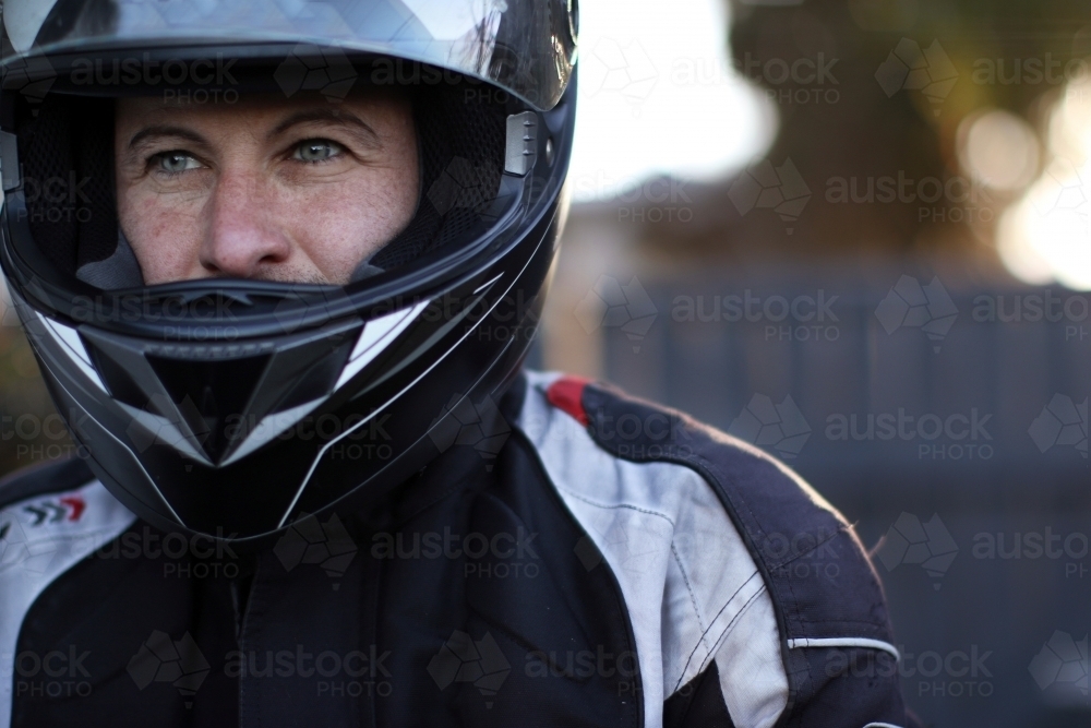 Close up of man wearing a motorbike helmet - Australian Stock Image
