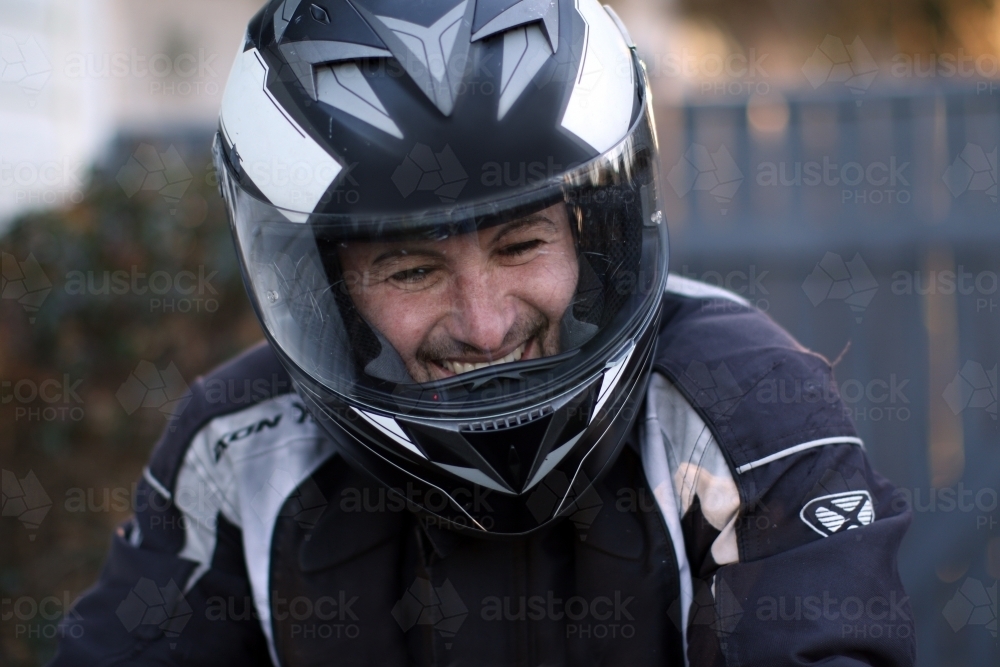 Close up of man wearing a motorbike helmet - Australian Stock Image
