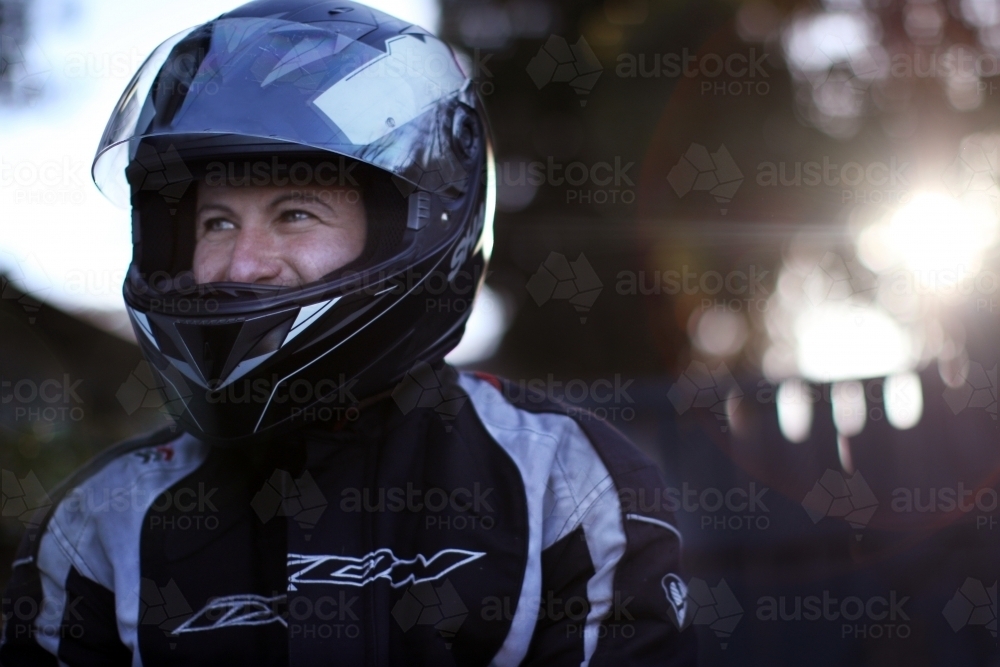Close up of man wearing a motorbike helmet - Australian Stock Image