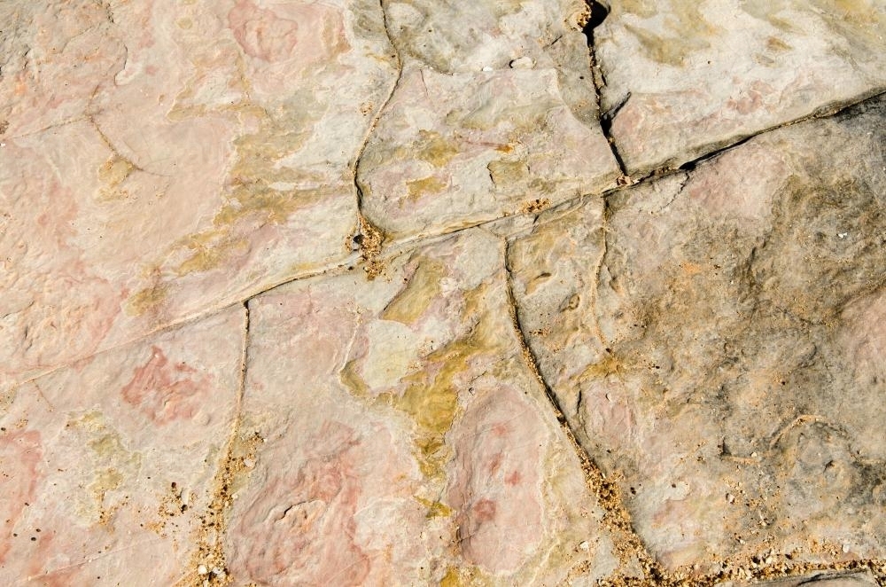 Close up of marbled rock with cracks and pink colours - Australian Stock Image