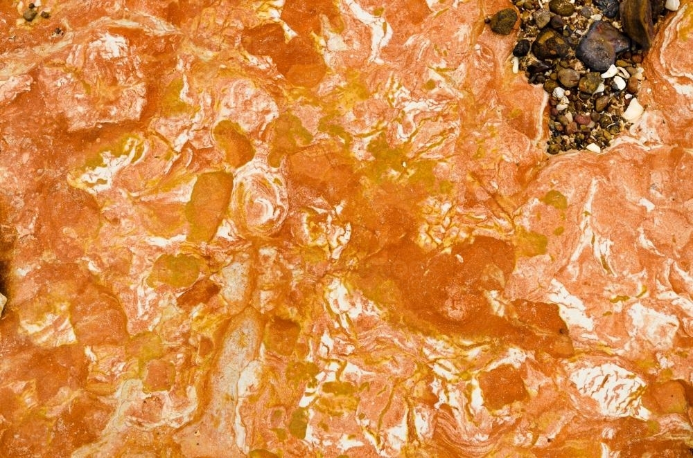 Close up of marbled rock with orange colours - Australian Stock Image