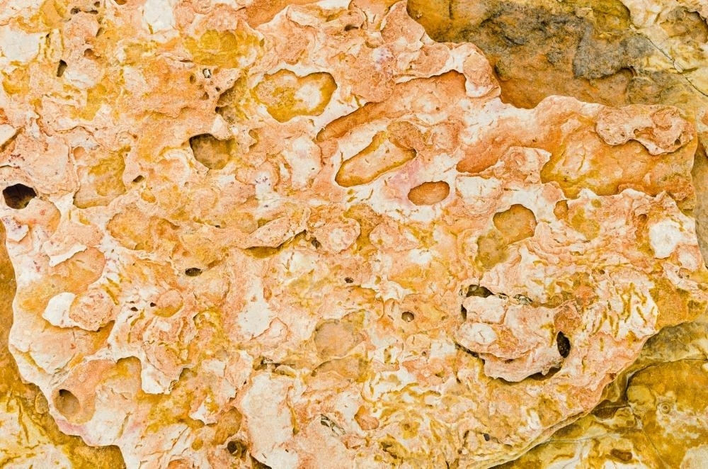Close up of marbled rock with orange colours - Australian Stock Image