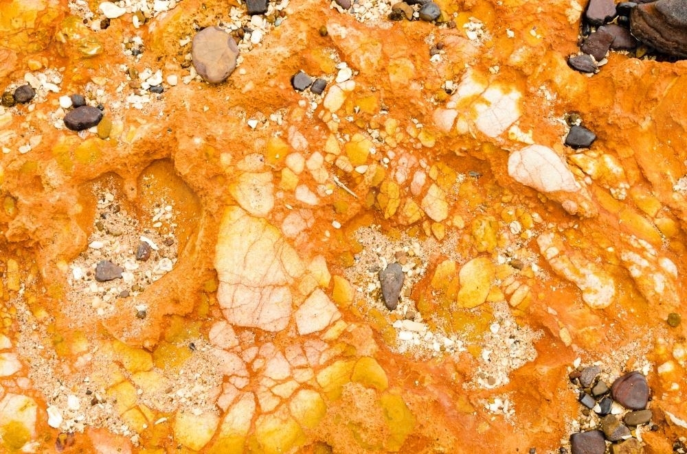 Close up of marbled rock with orange colours - Australian Stock Image