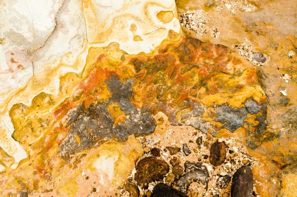 Close up of marbled rock with yellow colours - Australian Stock Image