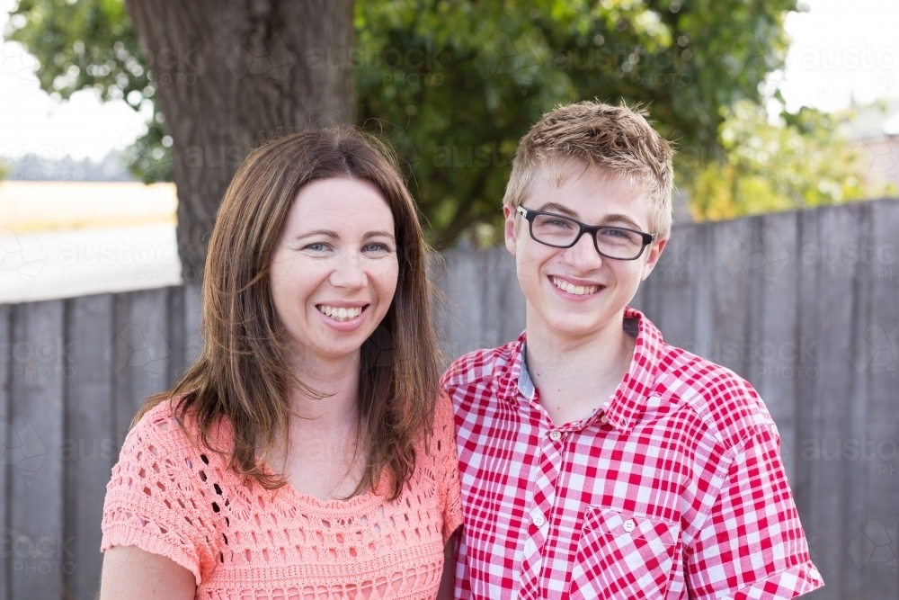 Close up of mother and teenage son smiling - Australian Stock Image