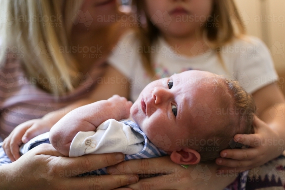 Close up of newborn baby looking at camera - Australian Stock Image