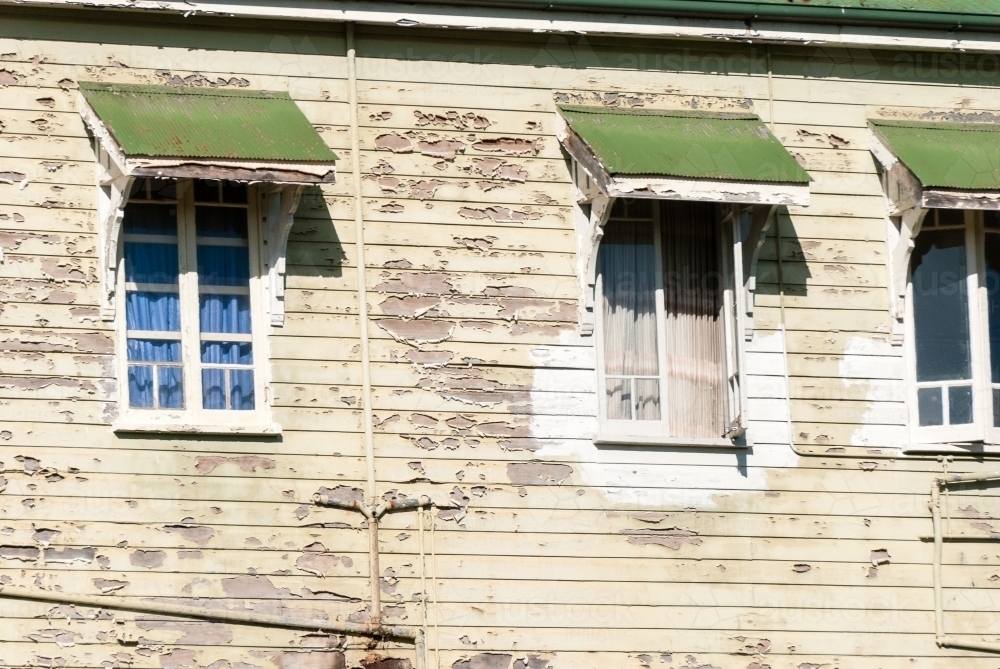 Close up of Paint Peeling on the side of an old Queenslander style House - Australian Stock Image
