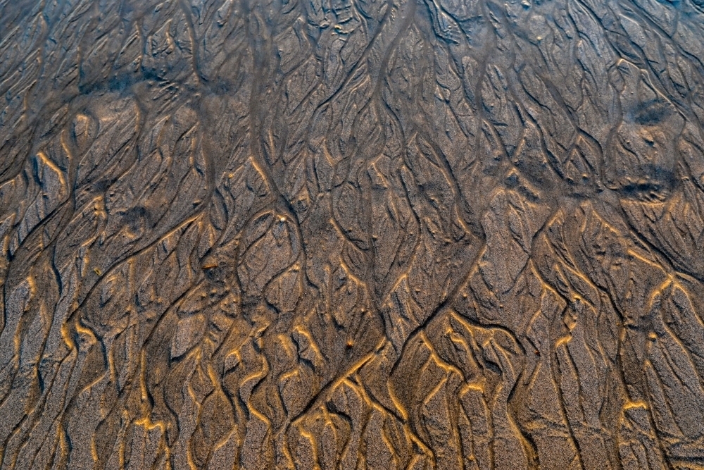 Close up of pattern in sand at low tide - Australian Stock Image