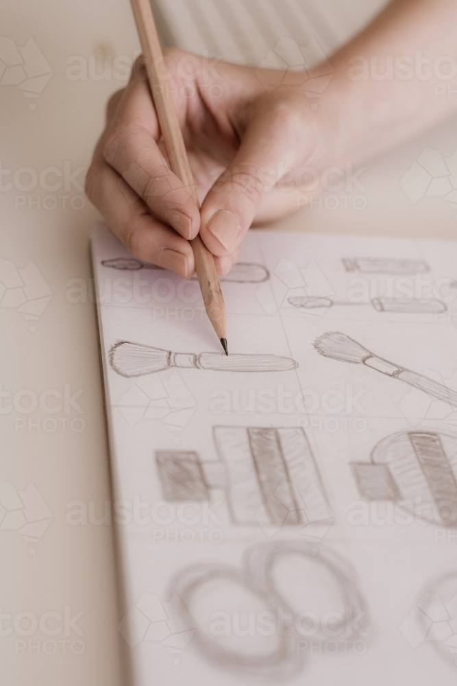 close up of pencil on paper with sketches - Australian Stock Image
