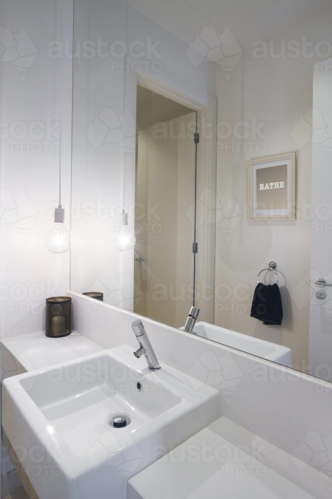 Close up of powder room basin tap and pendant lighting in modern home - Australian Stock Image