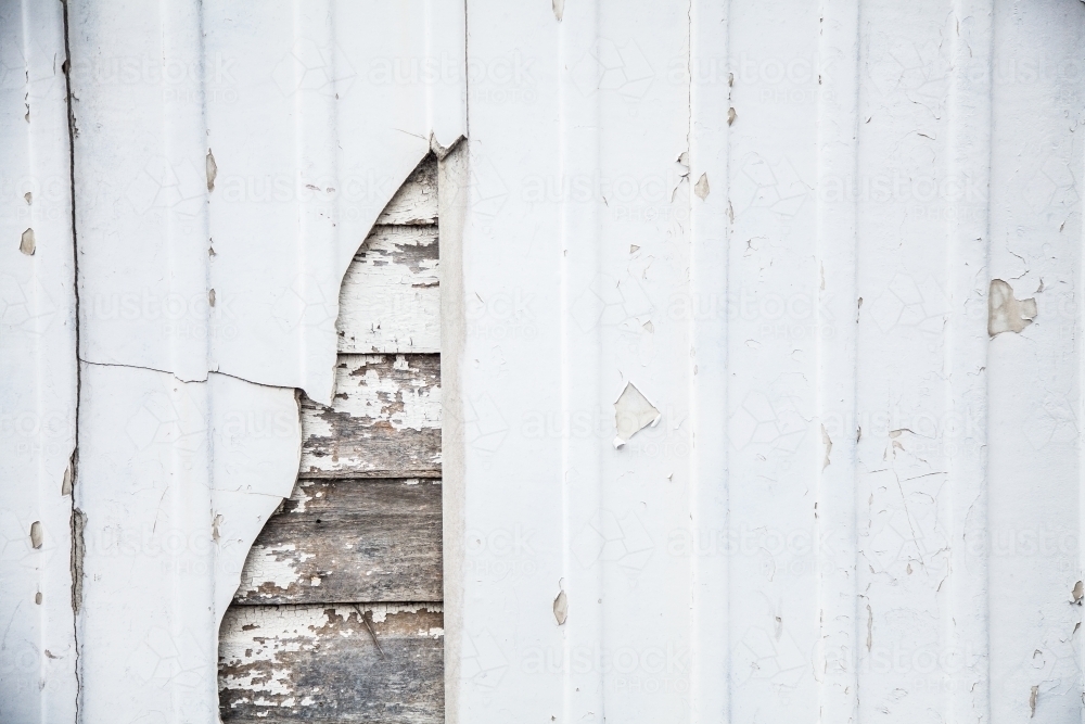 Close up of rustic timber slat panels hidden behind white wall - Australian Stock Image