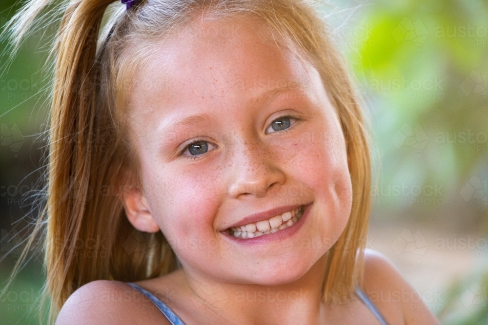close up of smiling young girl with dimples - Australian Stock Image