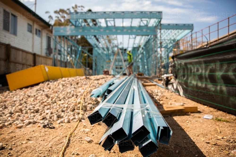 close up of steel frame pieces with construction in background - Australian Stock Image