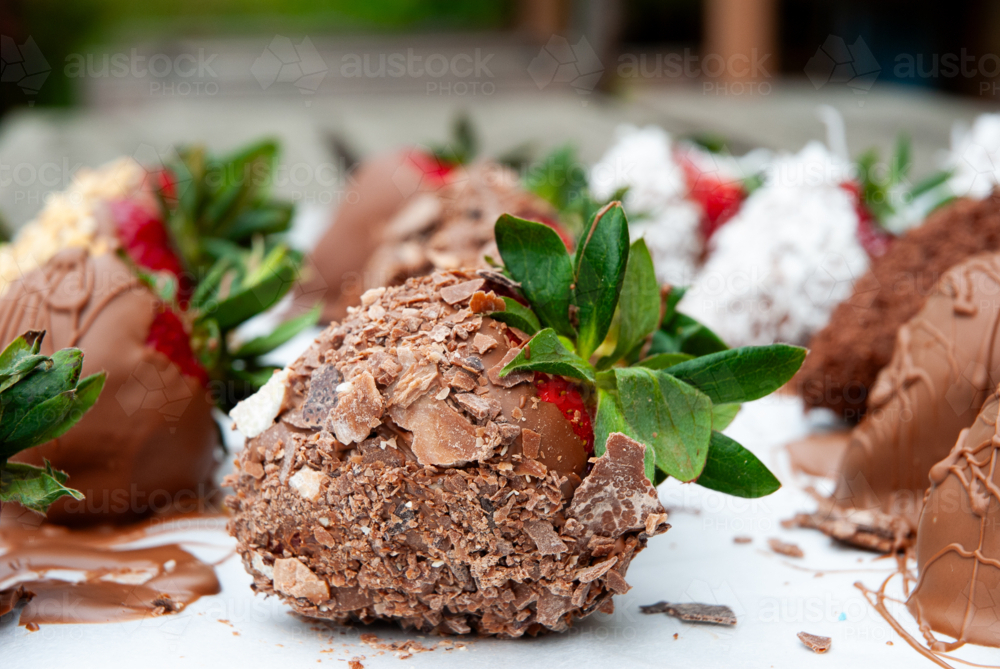 Close up of strawberries coated in chocolate on a plate - Australian Stock Image