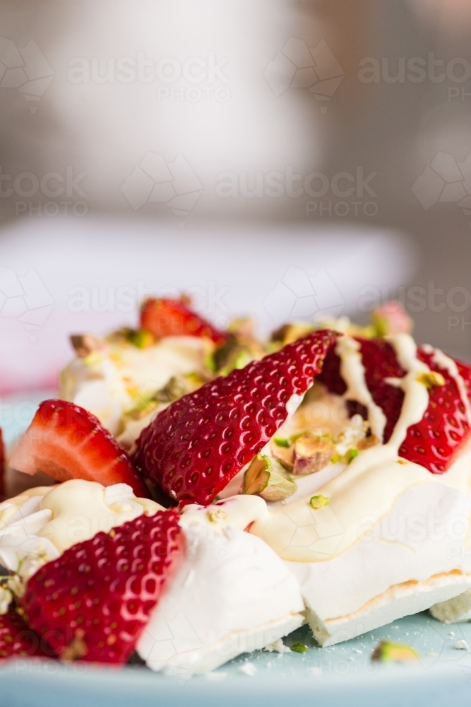 close up of strawberries on top of a pavlova, focus on the strawberry - Australian Stock Image