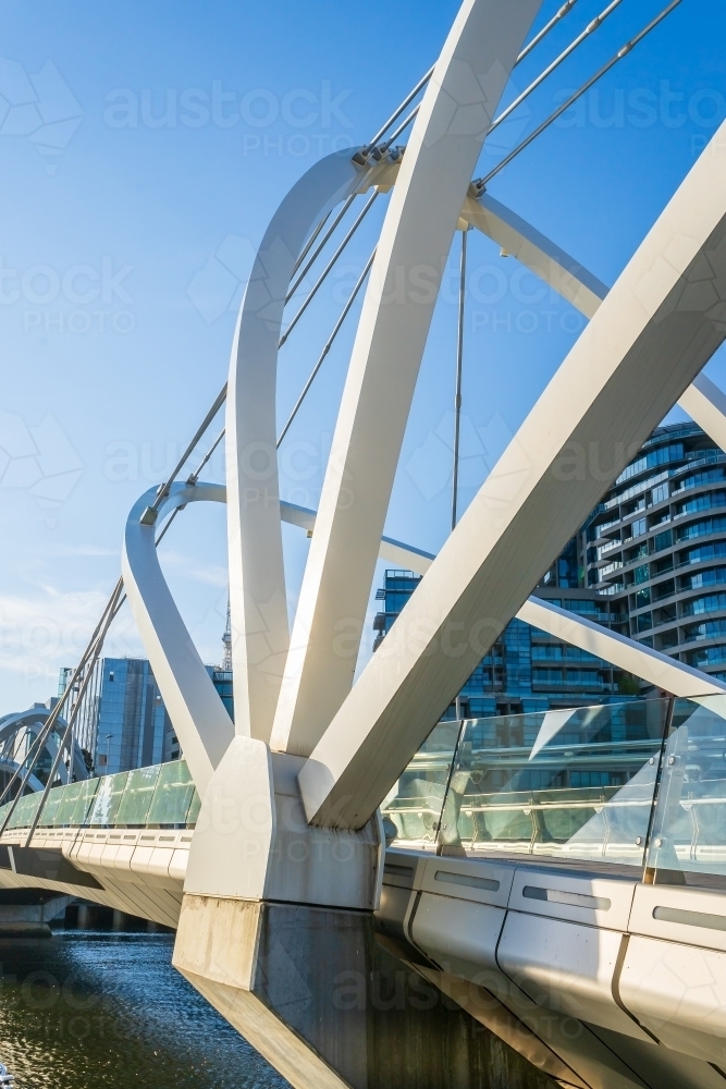 Close up of the arches of a modern inner city foot bridge. - Australian Stock Image