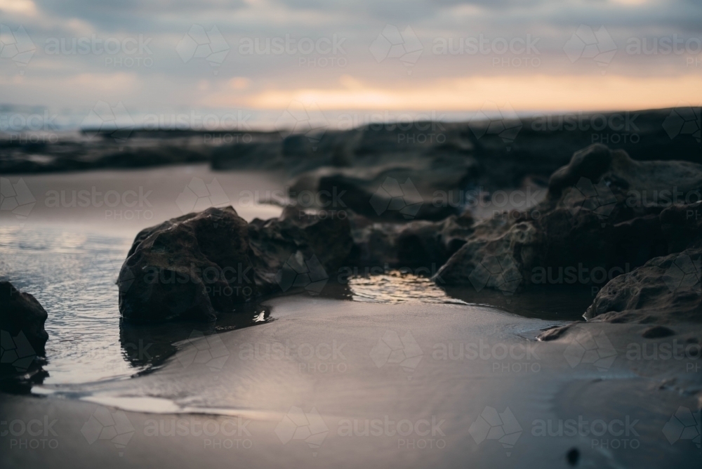 Close up of the sand and rocks at sunset - Australian Stock Image