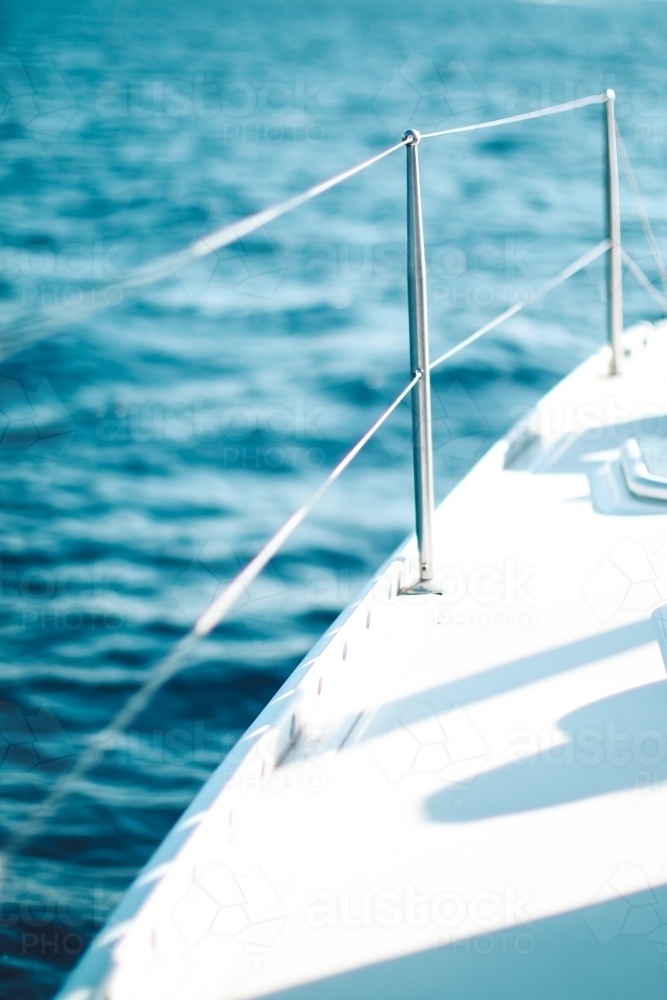 Close up of the wire railing of a boat on the ocean - Australian Stock Image