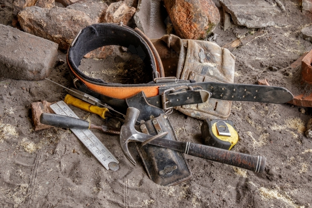 Close-up of tradesman's tool belt & on ground at building site - Australian Stock Image