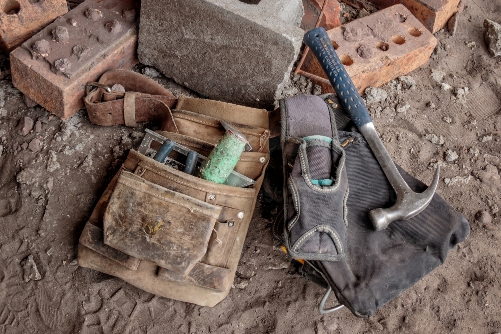 Close-up of tradesman's tool belt & tools on ground at building site - Australian Stock Image