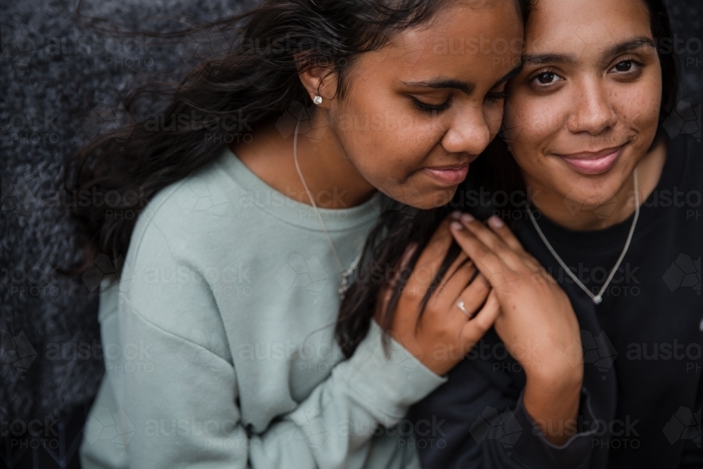 Image of Close-up of two Aboriginal girls hugging - Austockphoto