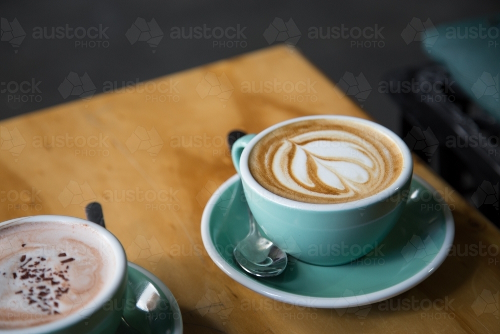 Close up of two coffee cups on a table in a cafe - Australian Stock Image