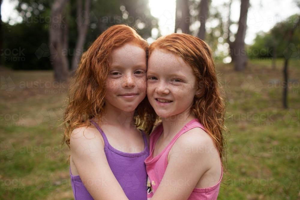 Close up of two girls hugging - Australian Stock Image