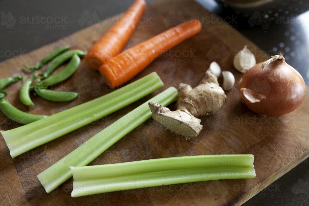 Close up of vegetables on chopping board - Australian Stock Image