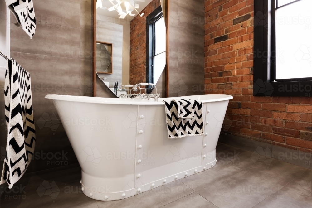 Close up of white freestanding bath tub in vintage interior style bathroom - Australian Stock Image