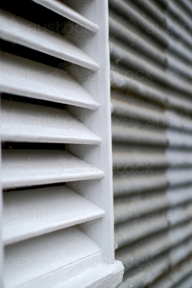 Close up of white timber louvre on corrugated iron shed - Australian Stock Image