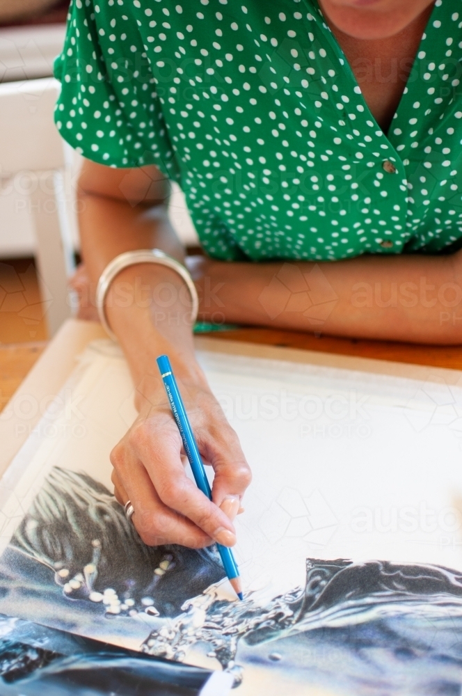 Close up of Woman drawing with coloured pencil - Australian Stock Image