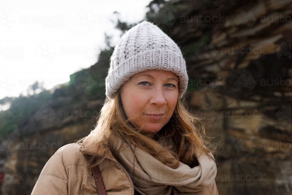 Close-up of woman with cliff face bakground - Australian Stock Image