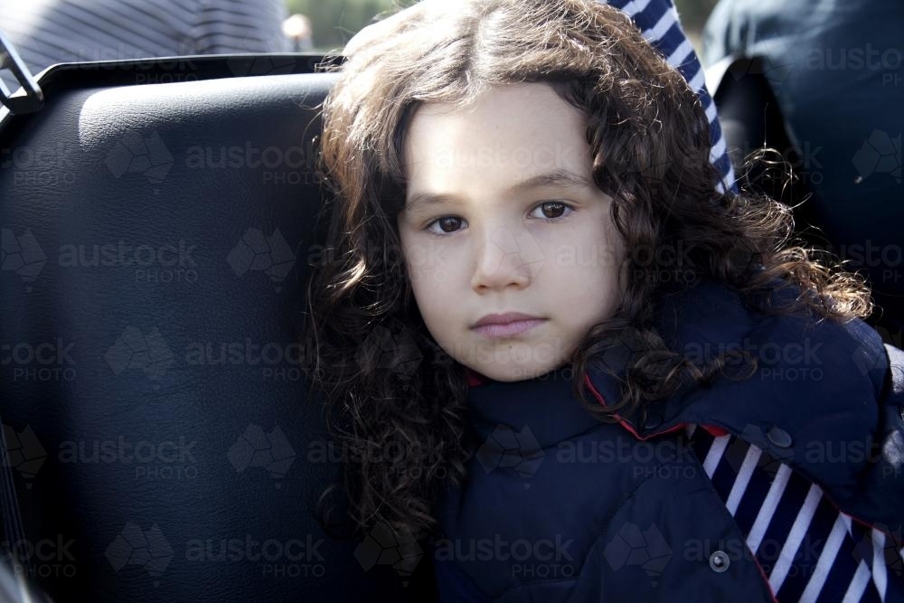 Close up of young brunette girl with serious expression - Australian Stock Image