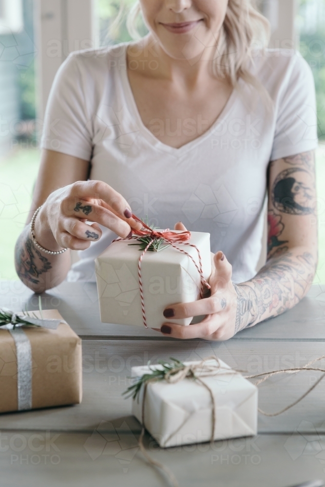 Close up of young female with gift wrapped Christmas present - Australian Stock Image