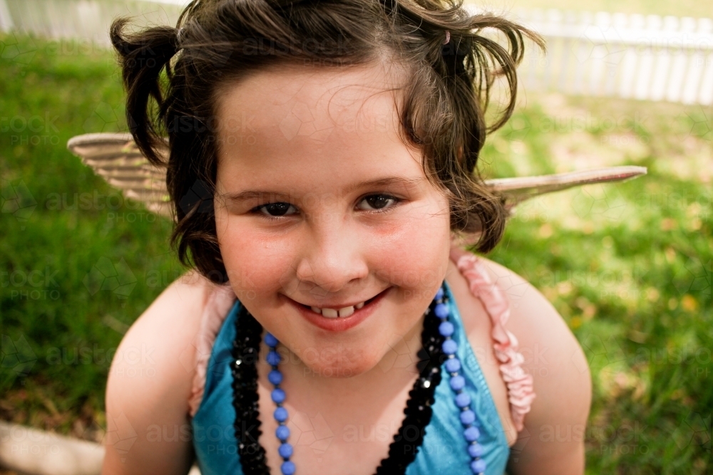 Close-up of young girl's face in blue leotard top - Australian Stock Image