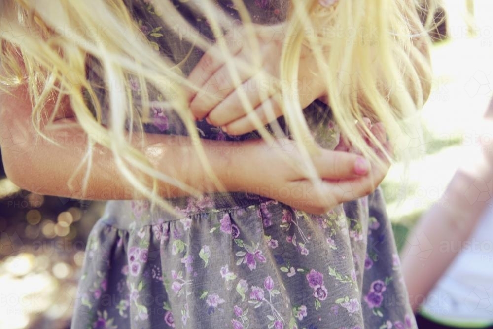 Close up of young girl with blonde hair in dress - Australian Stock Image