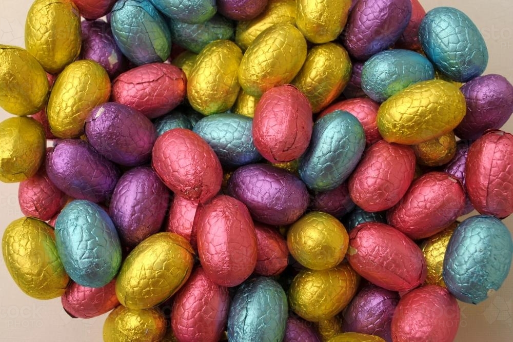 Close-up photo of chocolate Easter eggs in colourful foil - Australian Stock Image