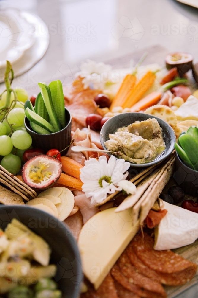 Close up photo of grapes, dragon fruit, cucumber, cheese, ham, fruits and vegetables - Australian Stock Image
