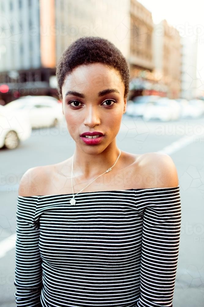 Close up portrait of a woman standing in the city on a street - Australian Stock Image