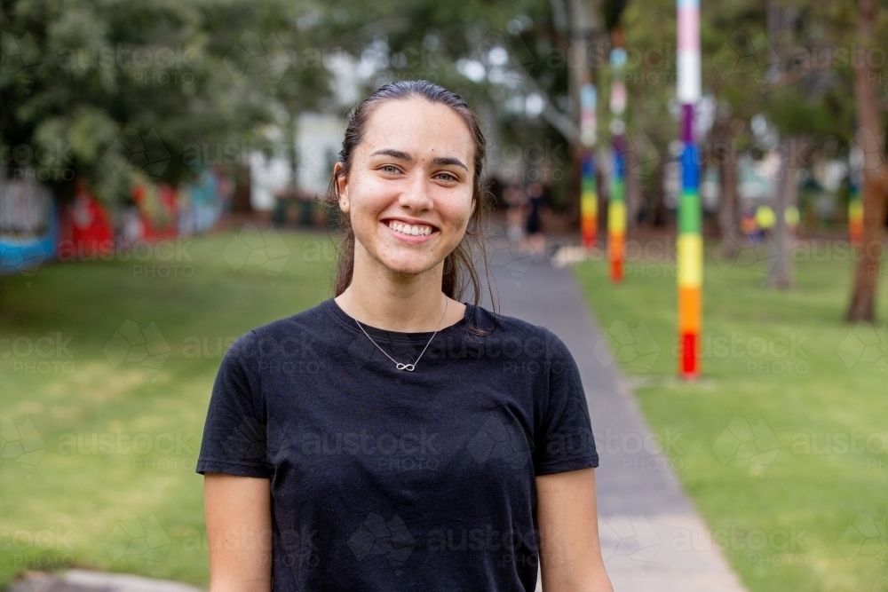 Close-up portrait of aboriginal woman smiling in a park - Australian Stock Image