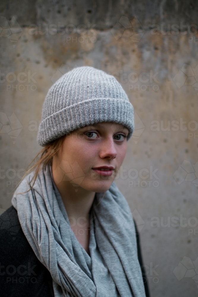 Close up portrait of young girl in a beanie looking at camera - Australian Stock Image