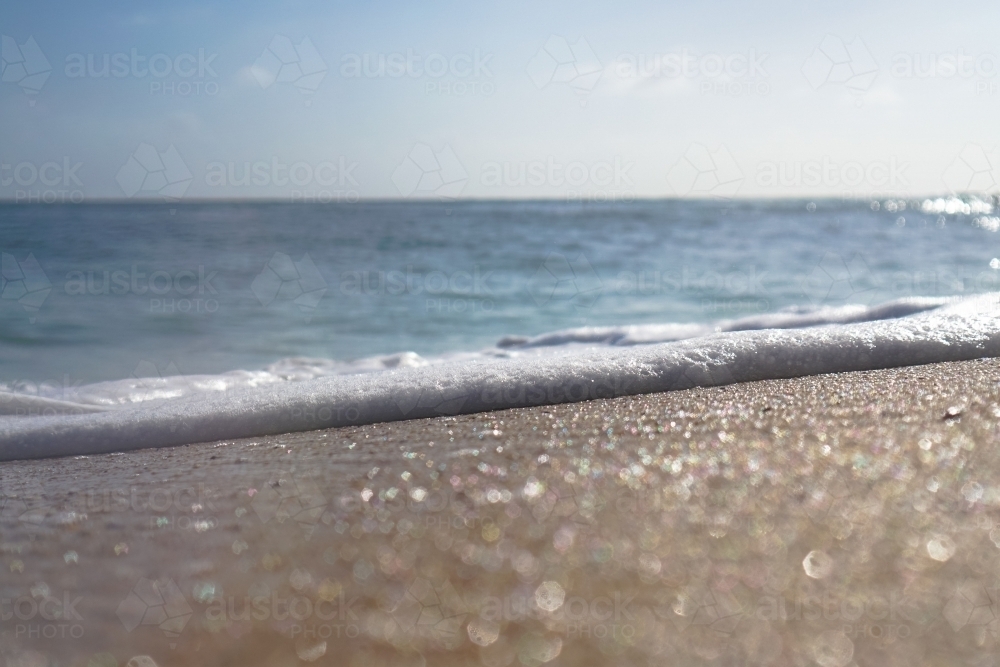 Close up sand and foam : Austockphoto Close up sand and foam - Australian Stock Image