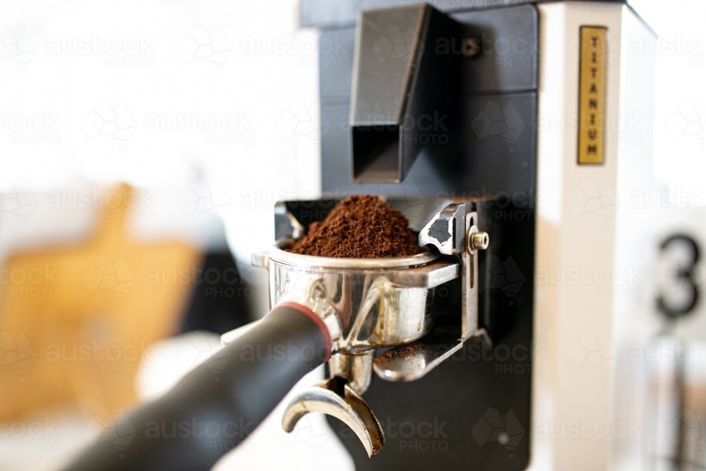 Close up shot of a coffee powder on a coffee machine in a coffee shop - Australian Stock Image