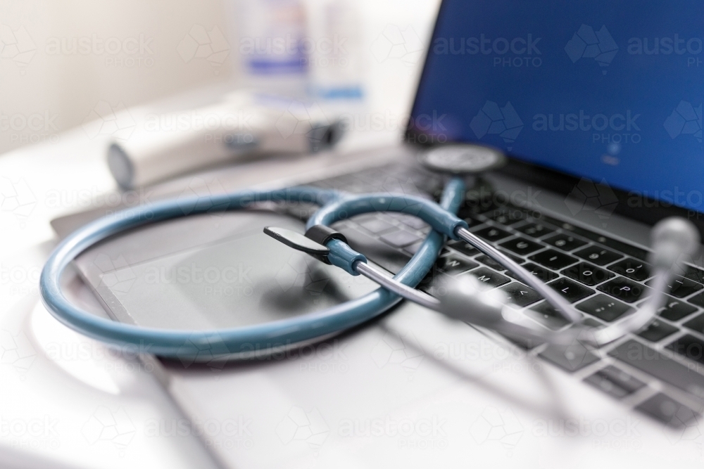Image of Close up shot of a stethoscope on a laptop keyboard - Austockphoto
