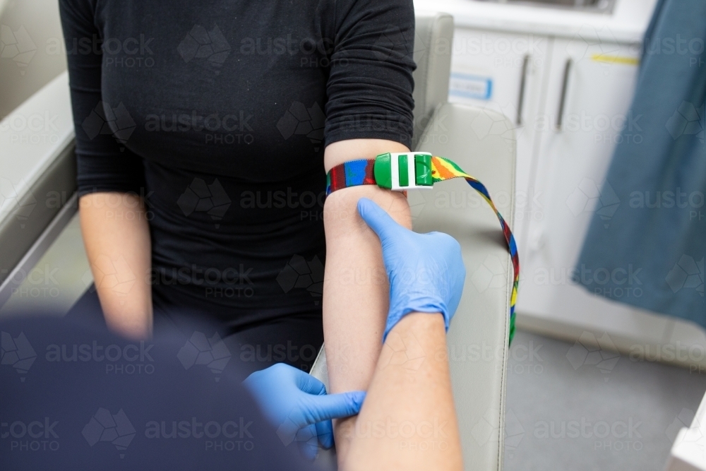 Image of Close up shot of a woman with a tourniquet on her arms for a blood test in the clinic