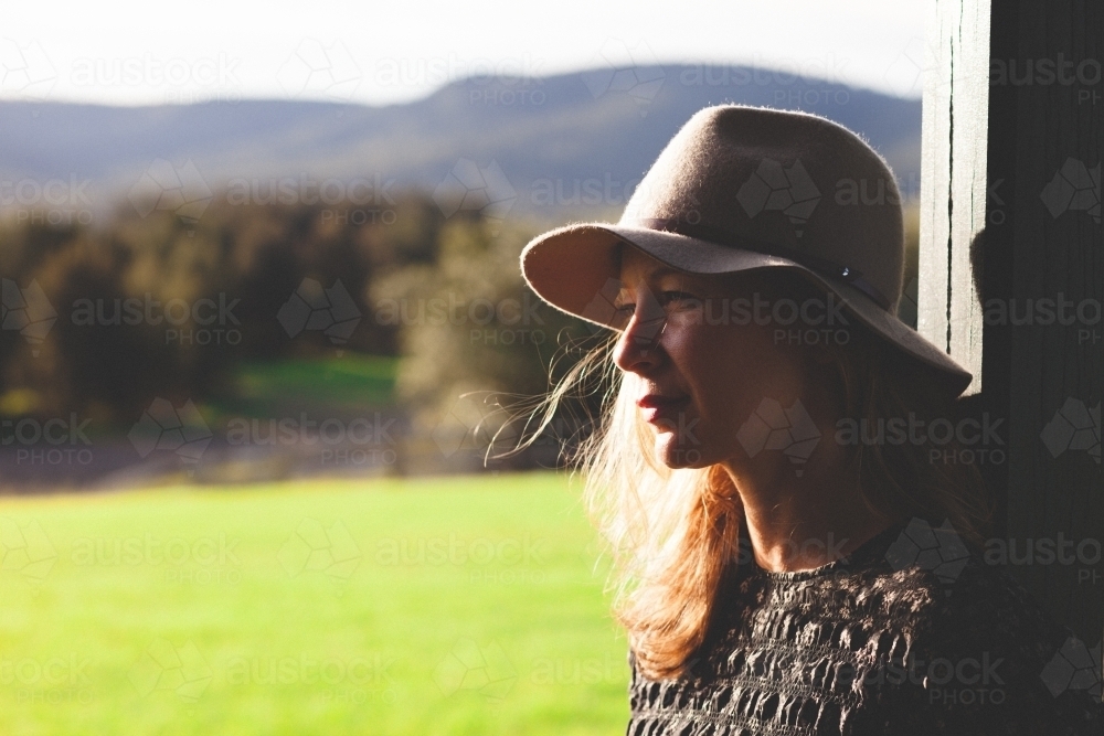 Close-up shot of a woman with countryside in the background - Australian Stock Image