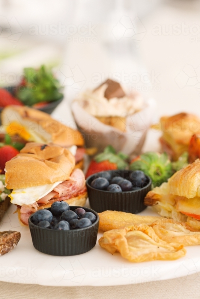 Close up shot of blueberries with sandwich on the side in a platter - Australian Stock Image